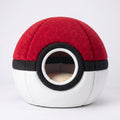 Red and white spherical cat cave bed with black center band and round entrance, beige plush interior