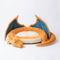 Orange winged dragon plush dog bed with soft raised bolster edges and cozy cushion.