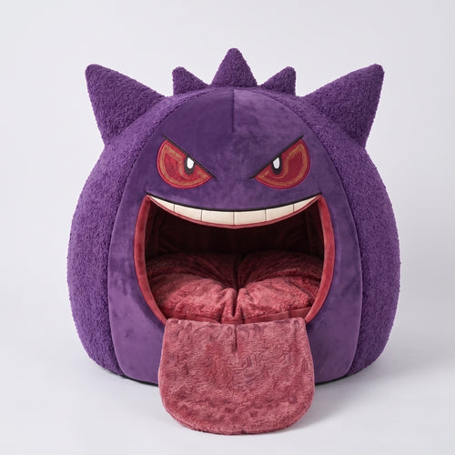Purple and red spherical cat cave monster bed with tongue and round entrance, redish-beige plush interior