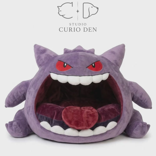 Purple monster cave pet bed with an open mouth design, white felt teeth, and soft red cushion.
