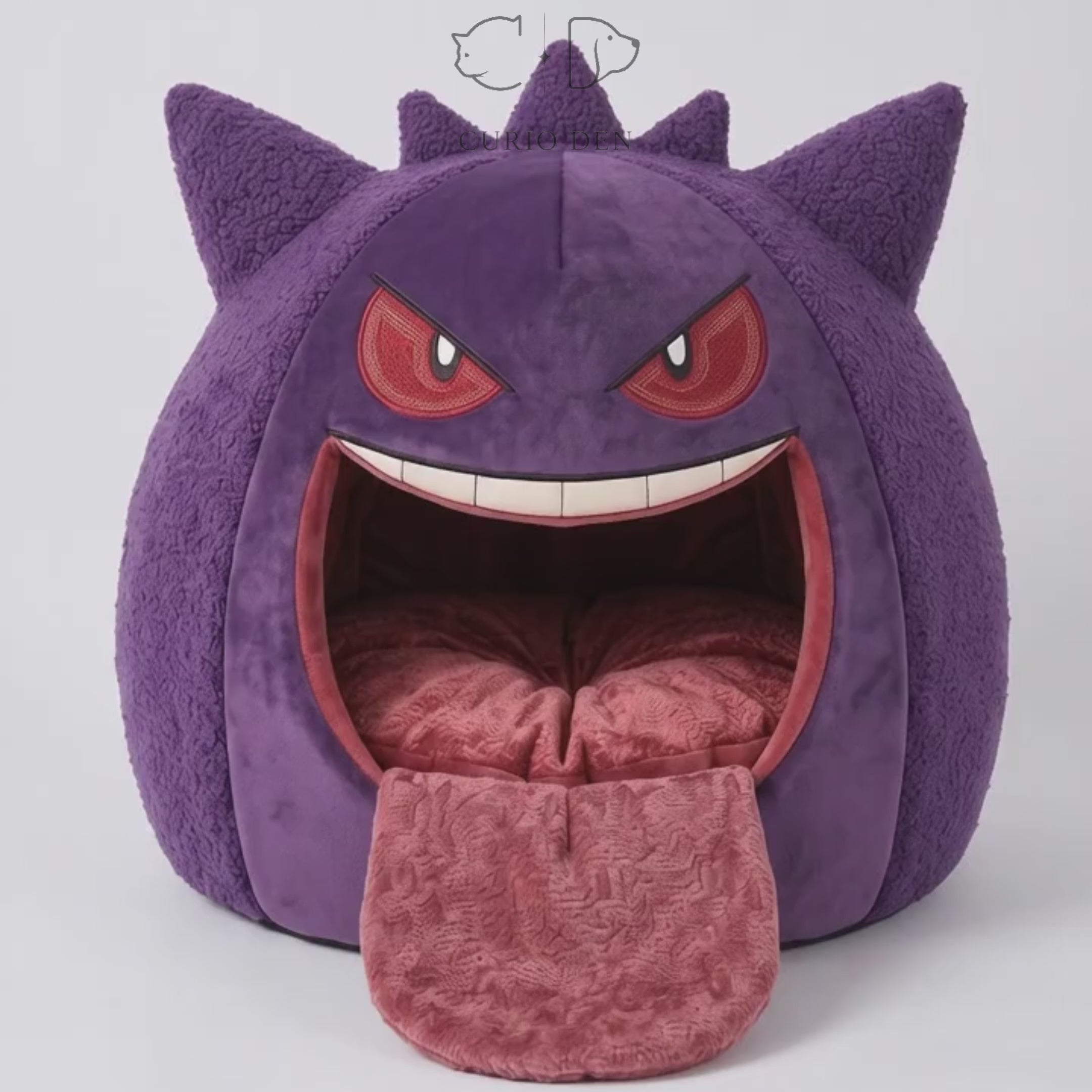 Purple and red spherical cat cave monster bed with tongue and round entrance, redish-beige plush interior