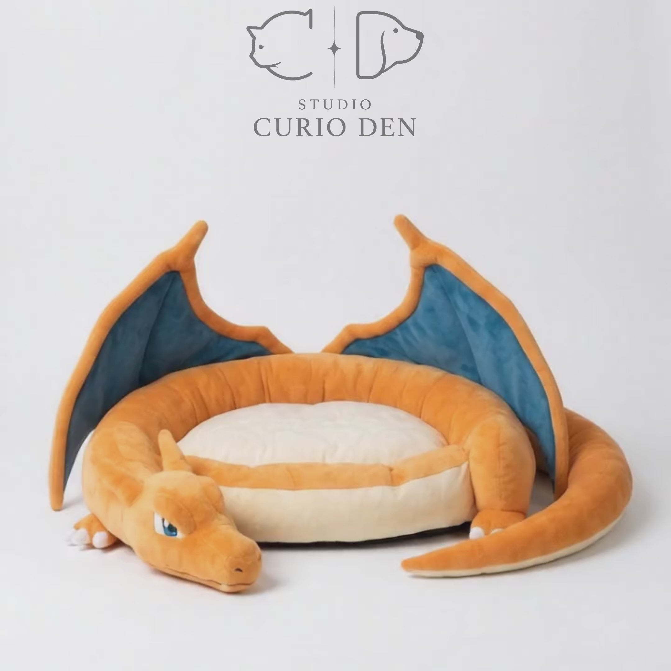 Orange winged dragon plush dog bed with soft raised bolster edges and cozy cushion.